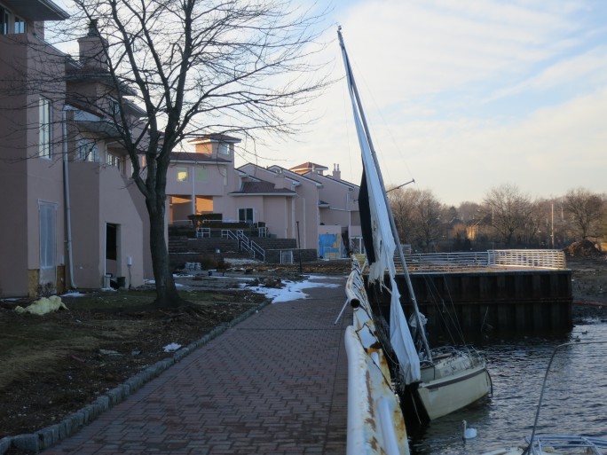 A sailboat washed up against the breakwater of the Port Regalle condominiums, awaiting salvage. 