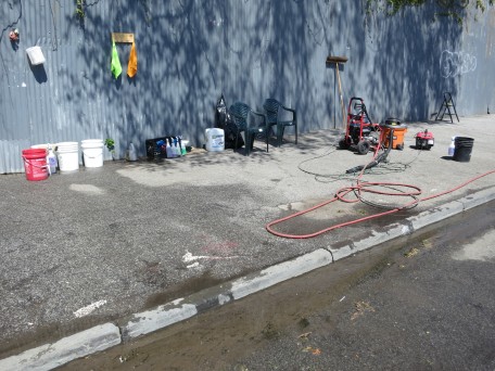 The sidewalk in front of Almonte’s car wash, with two chairs for waiting customers. At least four other illegal hand car-washes operate nearby.